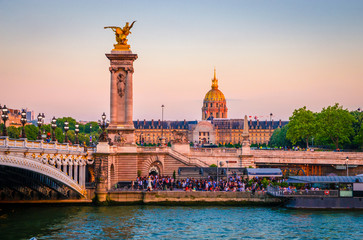 Fototapeta na wymiar Beautiful sunset view on Pont Alexandre III and Les Invalides in Paris, France