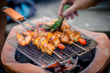 Grilling food, shrimp, on a charcoal stove. Makes the food taste a pleasant aroma. Most will cook themselves at home or at a restaurant.