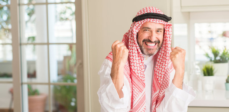 Middle age arabian man at home screaming proud and celebrating victory and success very excited, cheering emotion