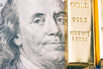 America US dollar banknote money with shiny ingot of gold as financial asset, safe haven of investment and wealth concept