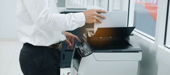 Bussiness man Hand press button on panel of printer scanner or laser copy machine in office - obrazy, fototapety, plakaty
