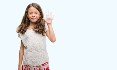 Brunette hispanic girl showing and pointing up with fingers number five while smiling confident and...