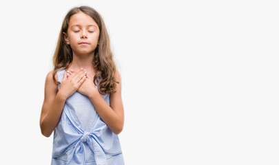 Brunette hispanic girl smiling with hands on chest with closed eyes and grateful gesture on face. Health concept.