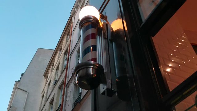 Turning barber pole lamp outside of restaurant 4K