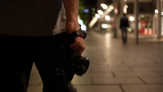 photograph walking at night with camera to bokeh