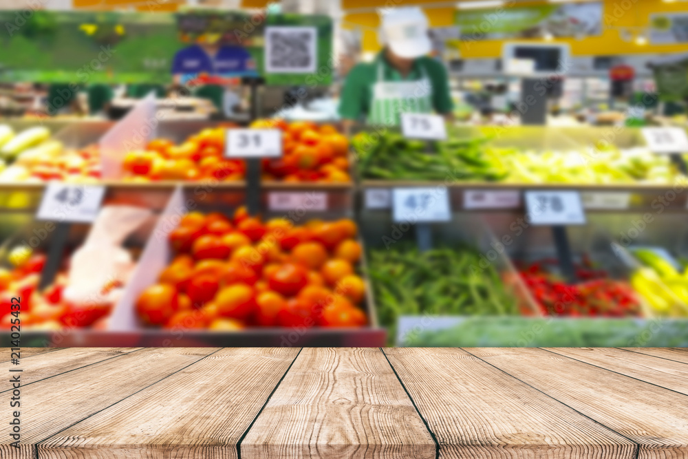 Wall mural Empty wood table top on shelf in supermarket blurred background