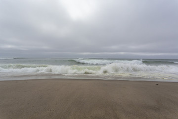 Front view of ocean waves at beginning of the storm. Heavy overcast.