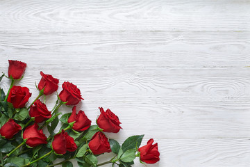 Bouquet of red roses on old white wooden background