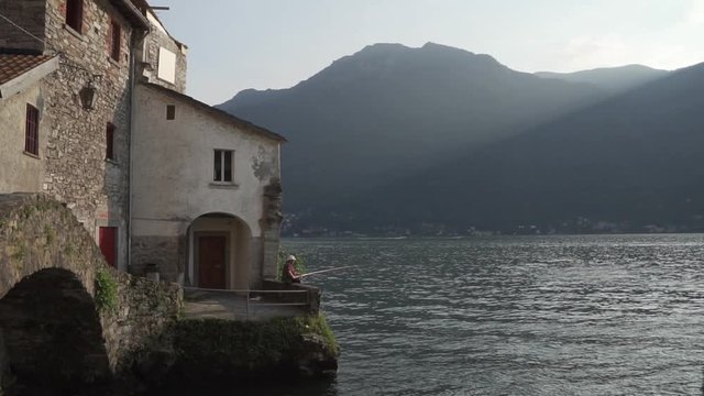 a lonely fisherman in nesso a wonderfull place in como lake italy lombardy North