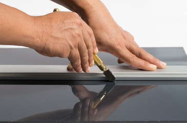 Technicians are using cutting tools, cut glass according to customer size