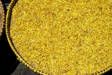 Yellow flower petals drying in the sun for tea in Bangkok Thailand