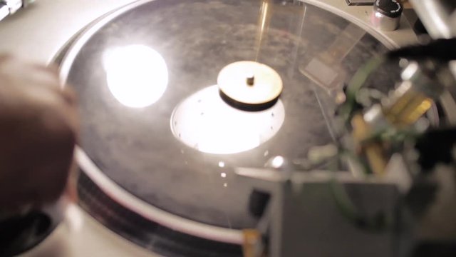 Man Cleaning New Vinyl Record On Turntable
