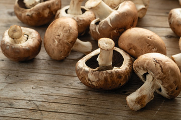 Mushrooms champignons royal scattered on a wooden background