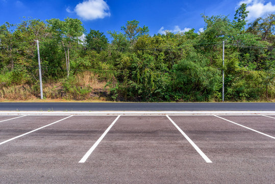 Empty parking lot with forest