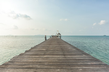 Long wooden bridge go to pavilion on the sea in beautiful tropical island, Thailand.