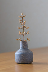 a beautiful vase with tiny branches of tree