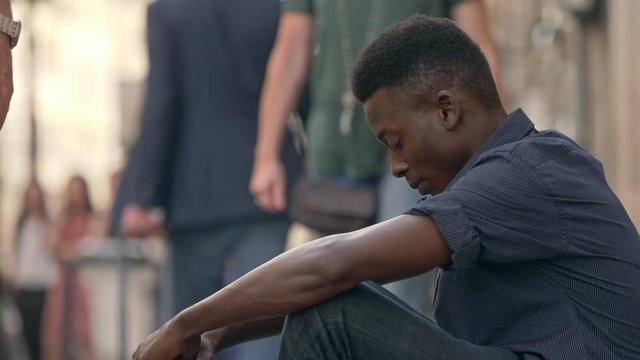 Lonely depressed black african man in the street. sadness,depression