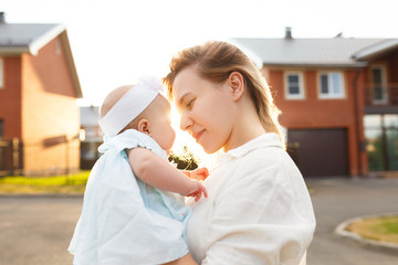 A positive view on the adoption of a child. A young woman loves her adopted daughter, holds her in...