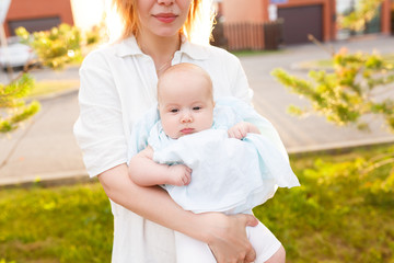 Help babysitting for busy parents. Cropped photo of nurse is holding a pupil's nursery. A young nanny walks with a baby outdoors during an evening walk before dinner and sleep