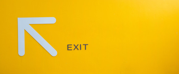 Yellow exit sign, empty space.