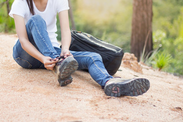 woman tying shoe laces, Closeup of female tourist getting ready for hiking, Hiking shoes .