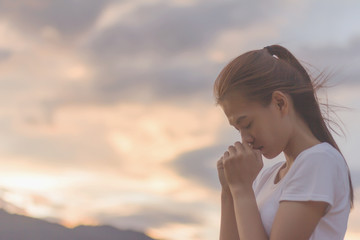 woman hands praying to god with the bible.  begging for forgiveness and believe in goodness....