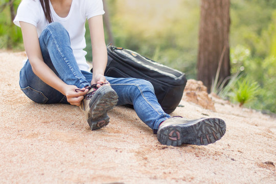 Woman Tying Shoe Laces, Closeup Of Female Tourist Getting Ready For Hiking, Hiking Shoes .