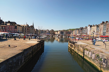 HONFLEUR, FRANCE-MAY 05, 2018: Yachts in the Honfleur harbor in a spring day. Color houses and...