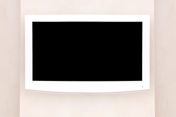 White LED TV with a black screen on a gray wall, mockup / mock up for designers.