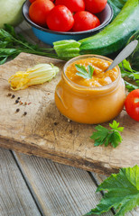 Squash zucchini paste in a glass jar surrounded by the ingredients