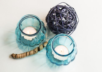 Natural decor accessories, candlesticks with burning candles on white background.