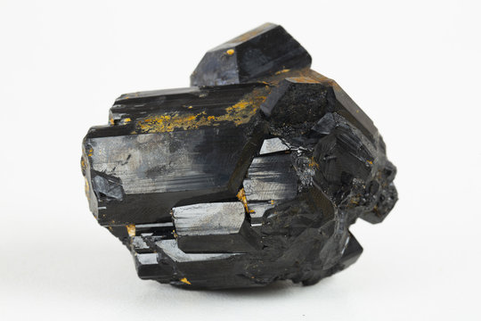 Extreme close up of black tourmaline mineral isolated over white background in focus stacking technique