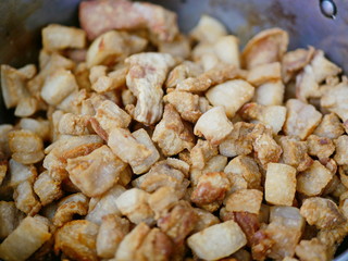 Closeup of brown crispy deep fried pork lard crackling (Gag Moo / khaep mu) - famous and popular small side dish among the Thais to dress up their noodles soup