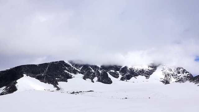 Time-lapse of the highest mountain in Sweden, Kebnekaise, as the clouds come in and cover it.