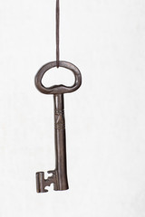 Big key hanging on a string, security concept