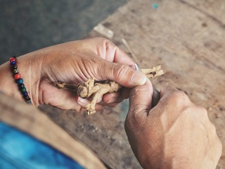 Carving wood cross and hand
