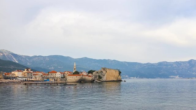 Time-lapse, view to the old city Budva at Adriatic sea coastline in Montenegro