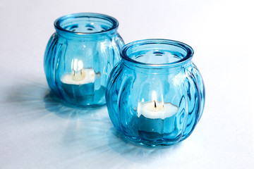 Accessories candlesticks with burning candles, blue composition for home, beauty and spa salons.