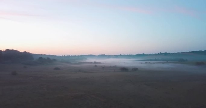 Beautiful ariel shot of the morning fog in danish nature. Specifially shot around Fårup sø, Vejle. 4am in the morning.
