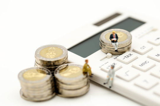 Miniature people : Businessman and friend with  calculator and stack of coins,business  finance concept.
