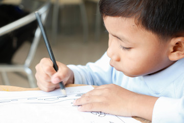 boy is drawing cartoon