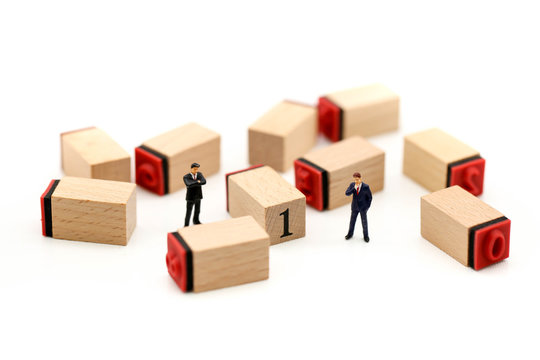 Miniature people : Businessman stand on number 1, 2 and 3 wooden block toys,Business , Success concept.