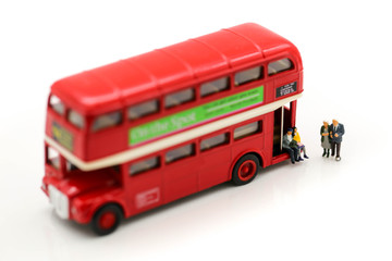 Miniature people : Couple of love waiting bus at bus station for go to destination plan
