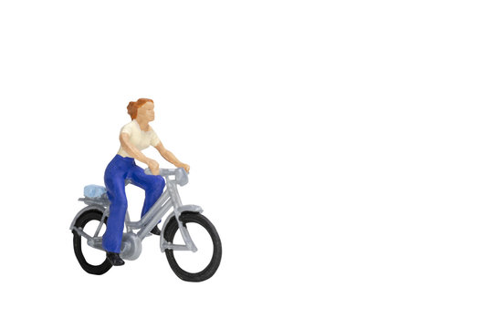 Fototapeta Miniature people travellers with bicycle isolate on white background with clipping path  