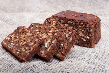 Fresh homemade bread on Sackcloth woven texture background. Selective focus.