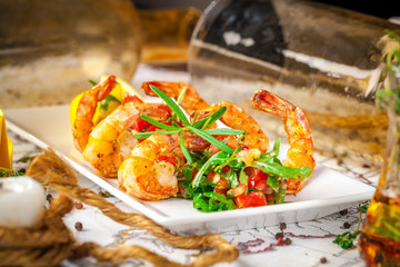 Balkan cuisine. Sea prawns with Mexican salsa on the background of geographical maps, rope and empty bottles. concept sea voyage. Copy space, selective focus