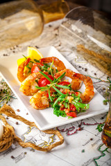 Balkan cuisine. Sea prawns with Mexican salsa on the background of geographical maps, rope and empty bottles. concept sea voyage. Copy space, selective focus