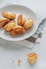 Homemade madeleine on mable background. 