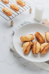 Homemade madeleine on mable background. 