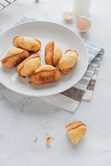 Homemade madeleine on mable background. 